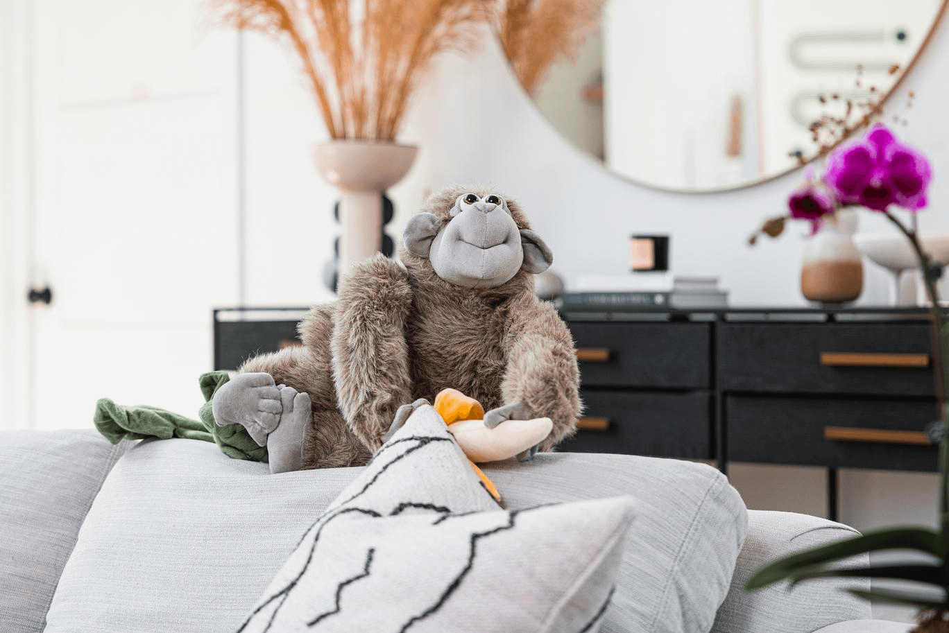 Plush monkey on grey couch