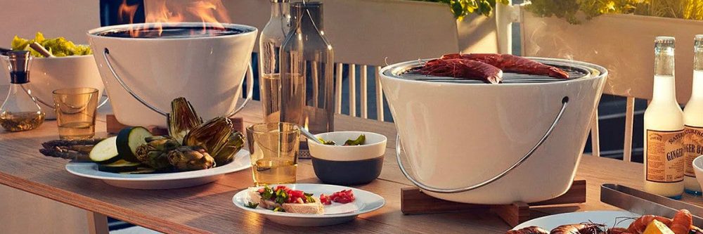 A table set up with two Eva Solo porcelain grills and other food and drinks